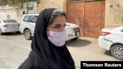 FILE - Saudi activist Loujain Al-Hathloul makes her way to appear at a special criminal court for an appeals hearing in Riyadh, Saudi Arabia, March 10, 2021. 