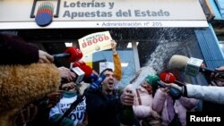 Rodrigo Merino celebrates after winning a prize in Spain's traditional Christmas lottery "El Gordo" outside the lottery store where he bought his ticket in Madrid on Dec. 22, 2023.