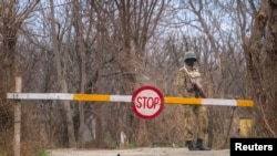 FILE - A Pakistani soldier stands guard at a checkpoint in the town of Khwazakhela, in Pakistan's northwestern Swat valley, home to several of the country's military bases, Feb. 4, 2014. 