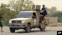 FILE - This still image taken from video provided by Arab 24 shows Saudi-led forces fighting to retake the international airport of Yemen's rebel-held port city of Hodeida from Shi'ite Houthi rebels, June 16, 2018.