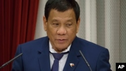 FILE - Philippine President Rodrigo Duterte delivers a speech at the official resident of Japanese Prime Minister Shinzo Abe in Tokyo, Oct. 30, 2017.