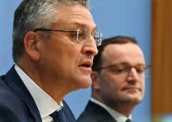 German Health Minister Jens Spahn, right, and the president of the Germany's Robert Koch Institute (RKI), Lothar Wieler, left, address the media about the current developments of the new coronavirus outbreak in Berlin, Germany, Oct. 8, 2020.