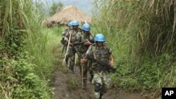 United Nations peacekeepers patrol near their encampment in the village of Kimua in the east of DRC, 3 Oct 2009