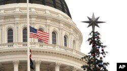 Flags fly at half staff at the Capitol, in Sacramento, California, to honor the victims of a mass shooting in San Bernardino, Dec. 2, 2015.