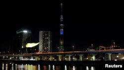 Tokyo Skytree is illuminated for a countdown to mark the two years until the opening of the Olympic Games Tokyo 2020 in Tokyo, Japan, July 24, 2018. 