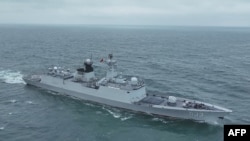 This undated handout photograph released on May 24, 2024, by the Eastern Theater Command of China's People's Liberation Army (PLA) shows a naval vessel sailing at sea during the "Joint Sword-2024A" military drill at an unknown location.