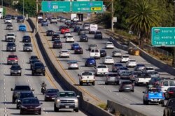 Traffic, at right, heads toward downtown along the 101 freeway in Los Angeles, April 16, 2020.