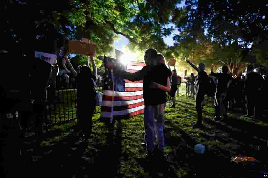 Demonstrators gather to protest the death of George Floyd, May 31, 2020, near the White House in Washington.