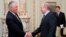 Russian Prime Minister Vladimir Putin, right, shakes hands with Rex W. Tillerson, chairman and chief executive officer of Exxon Mobil Corporation at their meeting in the Novo-Ogaryovo residence outside Moscow, Monday, April 16, 2012. Exxon is teaming up w