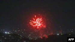 Celebratory gunfires light up part of the night sky after the last U.S. aircraft took off from the airport in Kabul, August 31, 2021. 