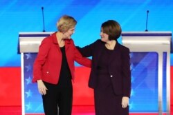 Democratic presidential candidates Sen. Elizabeth Warren (D-MA), left, and Sen. Amy Klobuchar (D-MN) greet each before the start of the Democratic presidential primary debate, Feb. 7, 2020, in Manchester, N.H.