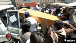 Afghan men carry the coffin of one of polio vaccination health workers shot and killed by unknown gunmen at separate locations in Jalalabad, Afghanistan, June 15, 2021.