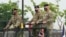 FILE - Incoming commander, Gen. Paul J. LaCamera, right, and outgoing commander, Gen. Robert B. Abrams, center, inspect the troops during a change-of-command ceremony in Pyeongtaek, South Korea, July 2, 2021.