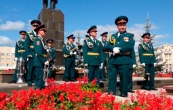 In this grab taken from a footage provided by the ROSATOM press service, a Russian military band prepare to attend the funerals of 5 Russian nuclear engineers, Aug. 12, 2019.