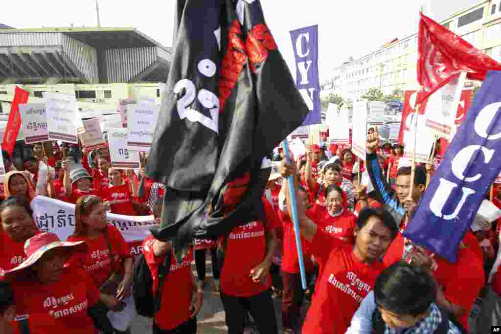 Cambodian garment workers hold banners during a gathering to mark May Day in Phnom Penh, Cambodia, May 1, 2016. The workers staged a rally to demand higher wages and better working conditions.