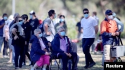 People are seen queuing at a coronavirus disease (COVID-19) testing site as the state of South Australia experiences an outbreak, in Adelaide, Australia, Nov. 17, 2020.