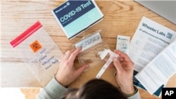 FILE - A saliva-based COVID-19 test is seen in this undated photo. The FDA on Tuesday approved a new, over-the-counter, at-home COVID test.