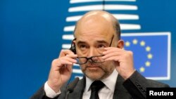 European Commissioner for economics, taxation and customs Pierre Moscovici attends a press conference after an euro zone finance ministers meeting in Brussels, Dec. 8, 2014. 