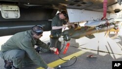 French military ground crew prepare a Mirage 2000 jet fighter for a mission to Libya, at Solenzara 126 Air Base, Corsica, Mar 23 2011