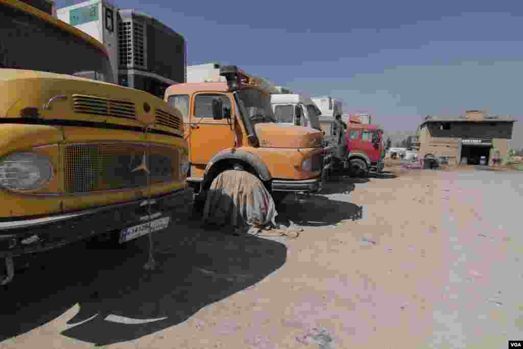 The truck stop used to get at least 50 trucks coming in for repair. Now, many are left to collect dust, unable to transport agricultural produce overland through Syria, Sept., 2015. (John Owens/VOA)