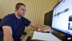 FILE - A technician calibrates sensors during a sleep study at Joint Base Lewis-McChord, Washington, Nov. 22, 2013. A recent Swiss study has found memories can be formed and vocabulary learning can take place in both conscious and unconscious states.
