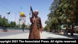 A Taliban fighter patrols inside the city of Ghazni, located in western Afghanistan, Aug. 12, 2021. 
