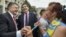 FILE - Ukrainian President Petro Poroshenko, left, and former Georgian President Mikheil Saakashvili, who now is governor of the Odessa oblast, are greeted by a local resident near the regional state administration in Odessa, May 30, 2015.