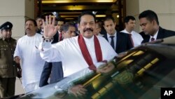 Sri Lankan Prime Minister Mahinda Rajapaksa waves after assuming duties as finance minister in Colombo, Sri Lanka, Oct. 31, 2018. 