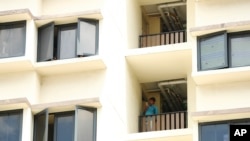 People wearing protective face masks exit a mall along the Orchard Road shopping belt in Singapore, April 10, 2020. 