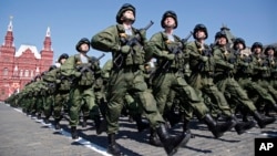 FILE - In this May 9, 2016 photo, Russian soldiers march during the Victory Day military parade marking 71 years after the victory in WWII in Red Square in Moscow, Russia. 