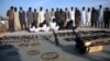 FILE - Arrested suspects and recovered weapons are displayed for the media by Pakistani paramilitary forces following a search operation in Shah Kass, an area of Pakistan's Khyber tribal region along the country's border with Afghanistan, March 3, 2017.