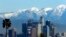 File - In this Jan. 12, 2016 file photo, the snow-capped San Gabriel Mountains stand as a backdrop to the downtown Los Angeles skyline. An initiative that seeks to split California into three states is projected to qualify for the state's November 2018 ballot.