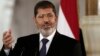 FILE - Egyptian President Mohammed Morsi speaks to reporters at the Presidential palace in Cairo, July 13, 2012.