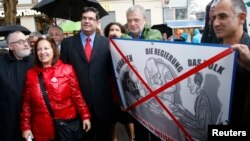 FILE - Rabbi Paul Chaim Eisenberg (L) and the President of the Jewish Community in Austria Oskar Deutsch (3rdL) participate in a protest against anti-Semitism in Vienna, Sept. 12, 2012.