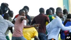Supporters of Congolese opposition leader Etienne Tshisekedi run as riot police charge with tear gas and live fire outside their candidate's headquarters in Kinshasa, Democratic Republic of Congo, December 8, 2011