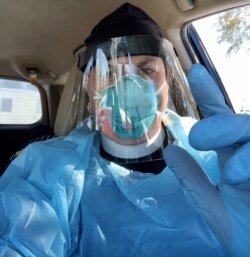 Episcopal Mission priest Lauren Stanley, seen here in full PPE as she transports patients to and from the Rosebud Reservation Indian Health Service hospital. (Courtesy: Rev.  Lauren Stanley)