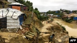 Rohingya children walk around a landslide area at Balukhali refugee camp in Ukhia, Bangladesh, July 7, 2019. 
