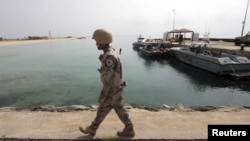 FILE - A Saudi border guard patrols Saudi Arabia's maritime border with Yemen along a beach on the Red Sea, near Jizan, April 8, 2015.