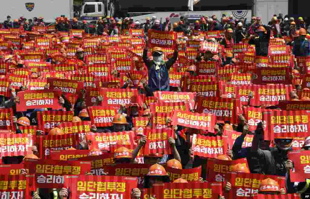 Members of the Korean Confederation of Trade Unions hold up their banners during a May Day rally in Seoul, South Korea.