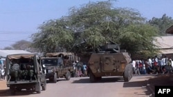 FILE - Kenya Defence Forces soldiers arrive at the scene of a bomb attack claimed by al-Shabab militants in the northeastern town of Mandera, northern Kenya, Oct. 25, 2016.