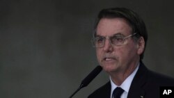 FILE - Brazil's President Jair Bolsonaro speaks during ceremony at the Planalto Presidential Palace in Brasilia, Brazil, March 25, 2019. 