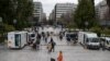 Medical staff of the National Health Organisation (EODY) conduct rapid tests for the COVID-19 as people queue in Syntagma square, central Athens, March 7, 2021.