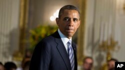 President Barack Obama arrives in the State Dining Room of the White House in Washington, June 14, 2013.