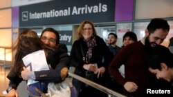 FILE - Behnam Partopour, a Worcester Polytechnic Institute (WPI) student from Iran, is greeted by his sister Bahar, left, at Logan Airport after he cleared U.S. customs and immigration on a student visa in Boston, Massachusetts, Feb. 3, 2017.