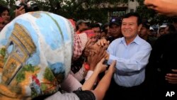 Cambodia National Rescue Party Deputy President Kem Sokha greets supporters during a rally in Phnom Penh, Cambodia, file photo. 