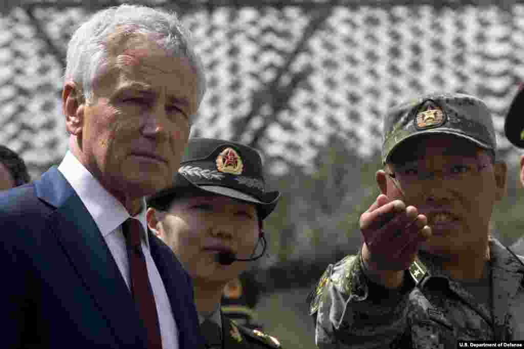 Secretary of Defense Chuck Hagel is given a tour by a Chinese military officer at the Non-Commissioned Officer Academy in Beijing, China, April 9, 2014. (Department of Defense)