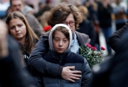 FILE - People mourn outside the synagogue in Halle, Germany, a day after two people were killed in a shooting.