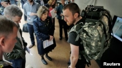 Visitors looks at the lightweight undersuit to reduce injuries & fatigue equipment during the DARPA (Defense Advanced Research Projects Agency) Demo Day exhibition at the Pentagon in Washington, May 11, 2016. 