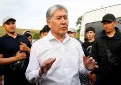 FILE - Kyrgyz former President Almazbek Atambayev, who was stripped of legal immunity after a parliamentary vote, and his supporters attend a meeting with journalists in the village of Koy-Tash near Bishkek, Kyrgyzstan June 27, 2019.