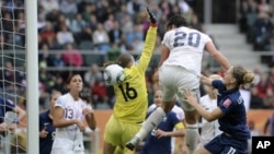 United States' Abby Wambach, center, scores during the Women's Soccer World Cup in Germany in 2011. 
